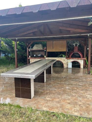 a bench sitting under a pavilion in the rain at LION VILLAGE in Skala Fourkas