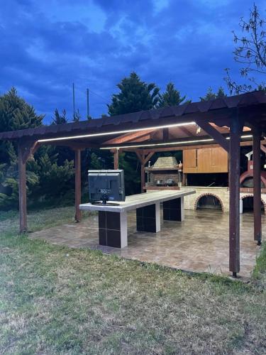 a pavilion with a table with a tv on it at LION VILLAGE in Skala Fourkas