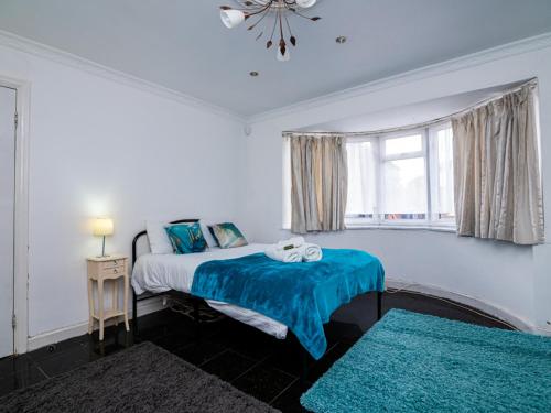 a bedroom with two beds and a window at Pass the Keys Beautiful Wembley Entire House in London