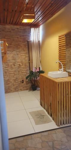 a bathroom with a sink and a counter at Pousada Monte Carlos in Galinhos