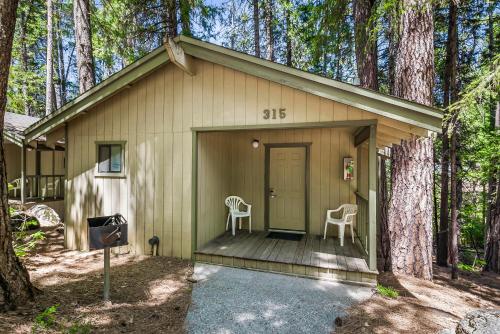 a small house with two chairs on a porch at Northern Queen Inn in Nevada City
