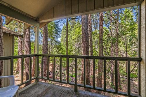 a screened in porch with a view of the forest at Northern Queen Inn in Nevada City