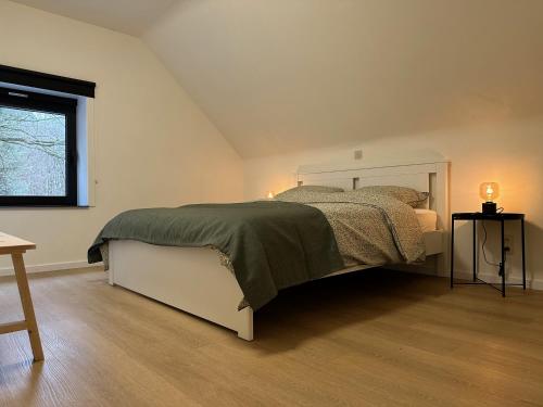 Postel nebo postele na pokoji v ubytování De Bovenbuur