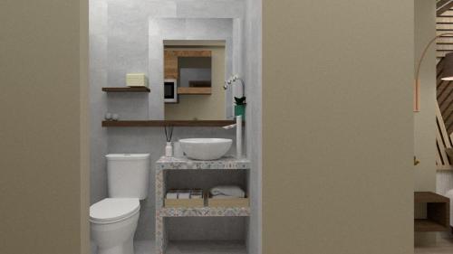 a bathroom with a white toilet and a sink at RHODIAN TREASJURE Spiridione Studios in Faliraki