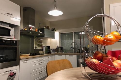 eine Küche mit einer Schale Obst auf einem Tisch in der Unterkunft "Logis Debussy"- Saintes in Saintes