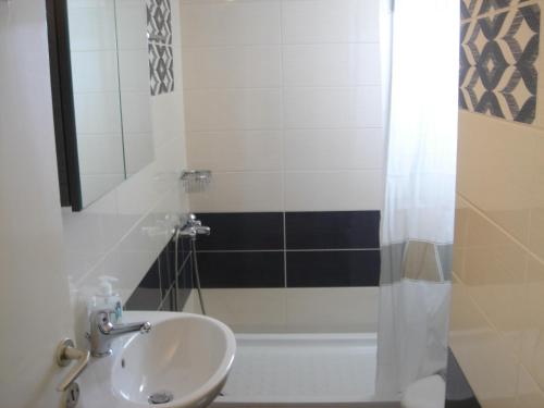 a bathroom with a sink and a shower at Neapolis Apartments in Palaiochóra