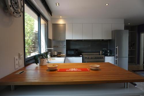 a kitchen with a wooden table with two bowls on it at KeschtaLoft - Gîte classé 4 étoiles in Châtenois