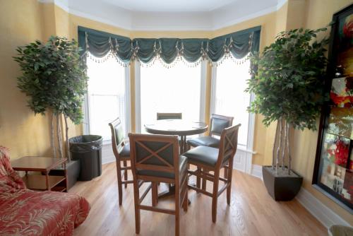a living room with a table and chairs and a window at City Villa Sleeps 10-20 Free TV & Parking in Chicago