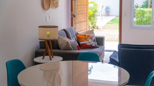 a living room with a couch and a table at Residencial Las Salinas in Maresias