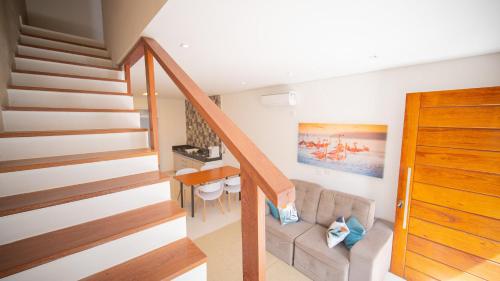 a living room with a couch and a table at Residencial Las Salinas in Maresias