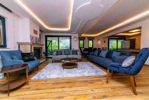 a living room with blue couches and a fireplace at House Sapphire in Marmaris