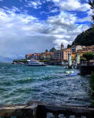 a view of a river with buildings and boats at Franca’s dream - Bellagio in Bellagio