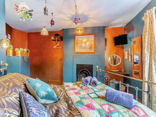 a bedroom with a bed and a fireplace at Buttress Retreat in Hebden Bridge