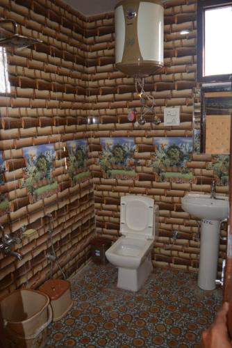 a bathroom with a toilet and a sink at Nice One Palace in Srinagar