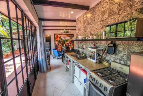 a kitchen with a stove and a counter top at Mikaso Hotel in San Pedro La Laguna