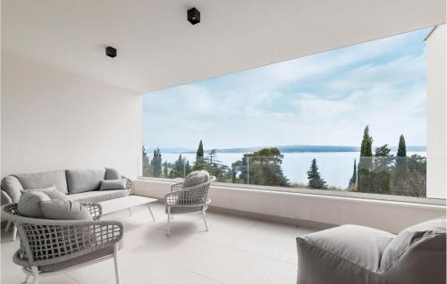a living room with a large window overlooking the water at Gorgeous Home In Dramalj in Dramalj