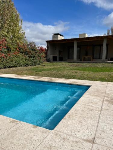 a swimming pool in front of a house at Rincón de Chacras de Coria in Ciudad Lujan de Cuyo