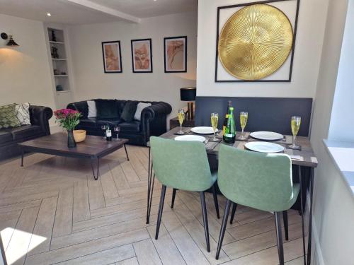 a living room with a table and chairs at Wesley Chapel- Cyanacottages in Whitby