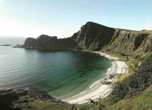 an aerial view of a beach with a mountain at House in the center of Andenes in Andenes