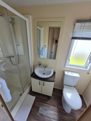 a bathroom with a toilet and a sink and a shower at Kielder in Morpeth