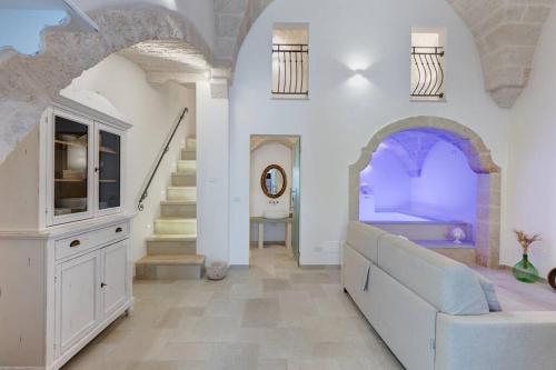 a living room with a couch and a staircase at Suite L' Alcova in Fasano