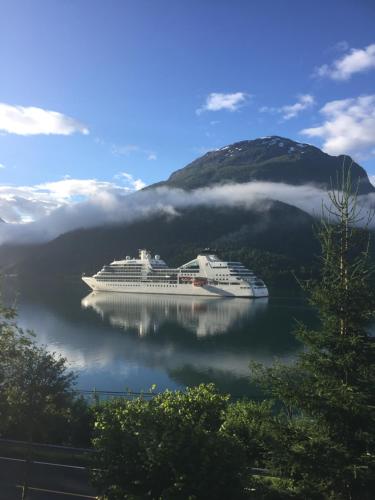 a cruise ship in a body of water at Solvik #apartment #Loen in Loen