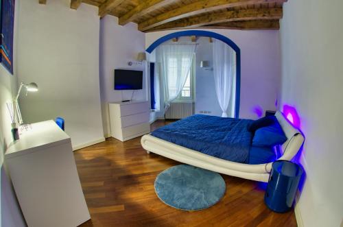 a bedroom with a bed with a large mirror at Blue Lodge in Brescia