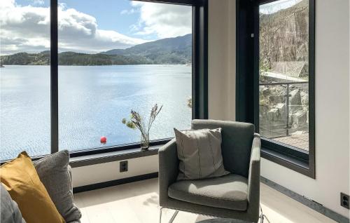 a living room with a large window with a view of the water at 3 Bedroom Awesome Home In Hebnes in Hebnes