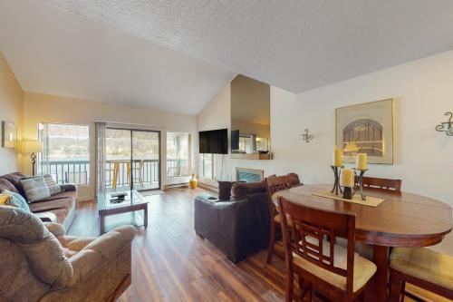 a living room with a table and a dining room at Bigfork Bliss in Bigfork