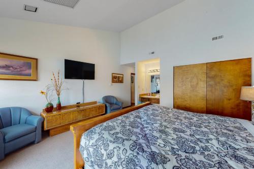a bedroom with a large bed and a tv at Bigfork Bliss in Bigfork