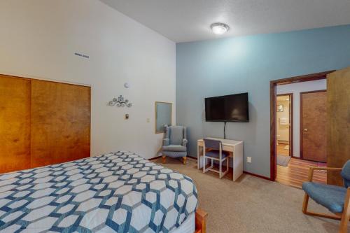 a bedroom with a bed and a flat screen tv at Bigfork Bliss in Bigfork