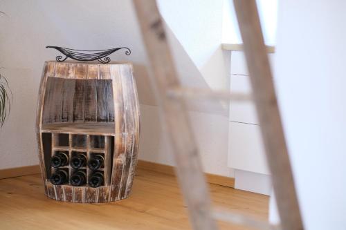 a glass wine bottle holder sitting on a wooden floor at Wohlfühloase am Trausdorfberg mit Sauna, Whirlpool und Panorama in Sankt Marein bei Graz