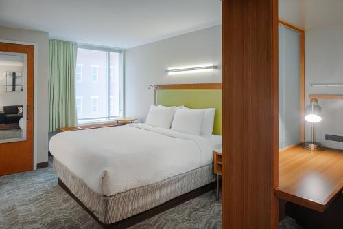 a hotel room with a large bed and a window at SpringHill Suites by Marriott Bloomington in Bloomington