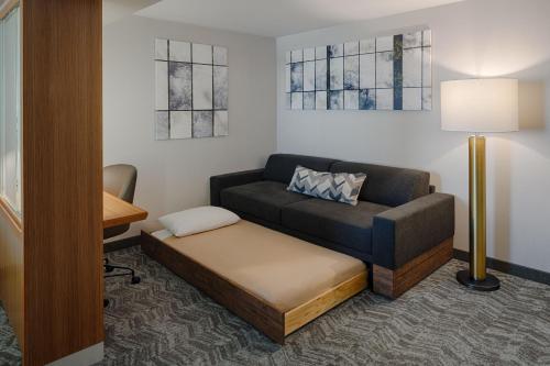 a living room with a couch and a bed at SpringHill Suites by Marriott Bloomington in Bloomington