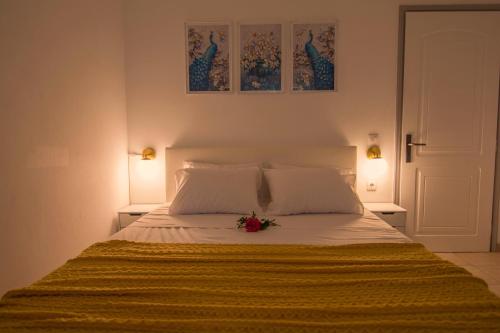 Ireon Holiday Home في إيرايون: سرير عليه بطانيه صفراء وزهره