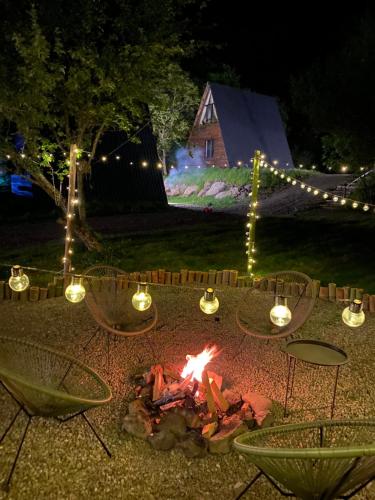 a fire pit in a yard at night with lights at Landhaus Borjomi in Borjomi