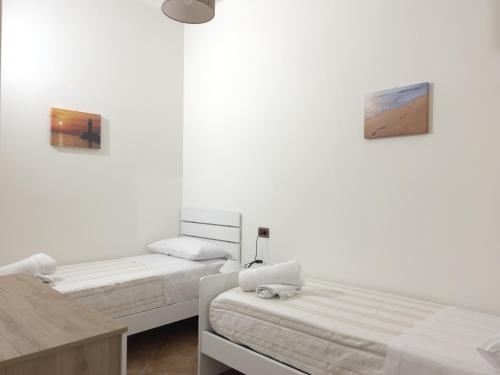La Capinera Holidays tesisinde bir odada yatak veya yataklar
