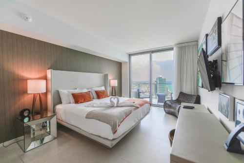 a bedroom with a large bed and a large window at Iconic Ocean View - in this Stunning Condo in Hollywood