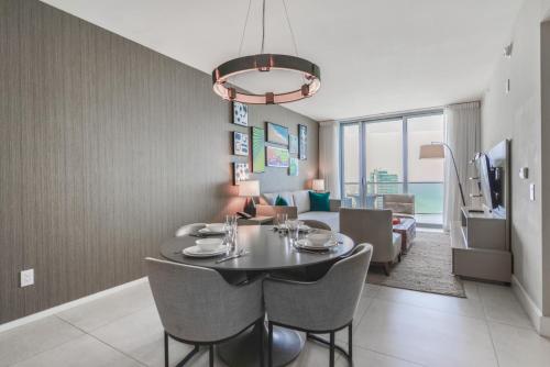 een eetkamer en een woonkamer met een tafel en stoelen bij Iconic Ocean View - in this Stunning Condo in Hollywood