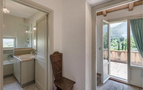 a bathroom with a sink and a toilet and a window at Soratte in Poggio Catino