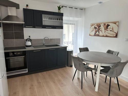 - une cuisine avec une table, une table et des chaises dans l'établissement Chez Gaëlle, à Trèbes