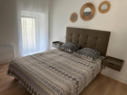 a bedroom with a large bed and a window at Chez Gaëlle in Trèbes