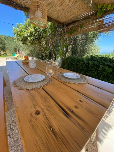 una mesa de madera con dos copas de vino. en Casa San Valentino en Vico del Gargano