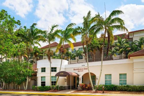 a hotel with palm trees in front of it at Residence Inn Fort Lauderdale SW/Miramar in Miramar