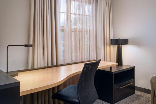a desk with a chair next to a window at Residence Inn Fort Lauderdale SW/Miramar in Miramar