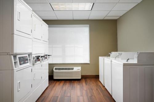a kitchen with white appliances and wooden floors at Residence Inn Fort Lauderdale SW/Miramar in Miramar