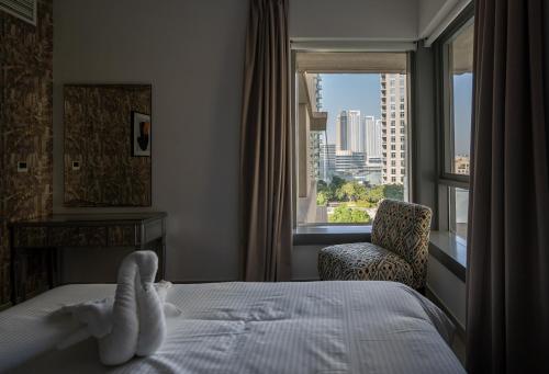 um quarto de hotel com uma cama com um bicho de peluche em BellaVista 2 BR 29 Boulevard Downtown Burj Khalifa em Dubai