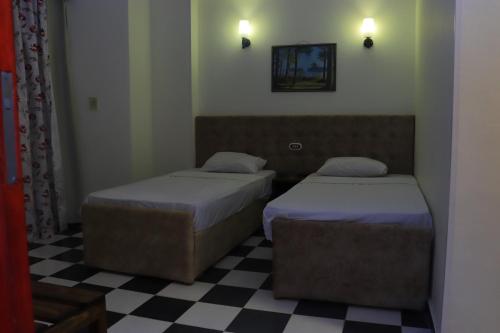 Ένα ή περισσότερα κρεβάτια σε δωμάτιο στο Royal City Hotel