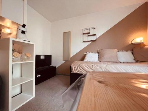a hotel room with two beds and a shelf at Urban Oasis Blancarde in Marseille