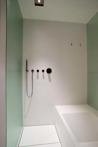 a white bathroom with a shower with a glass door at Mercer Casa Torner i Güell in Vilafranca del Penedès